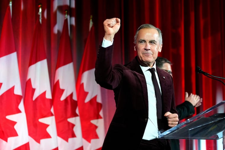 Canada's Prime Minister Mark Carney pumps his fist as he arrives to deliver remarks at the Liberal caucus holiday party in Ottawa, on Dec. 11, 2025.