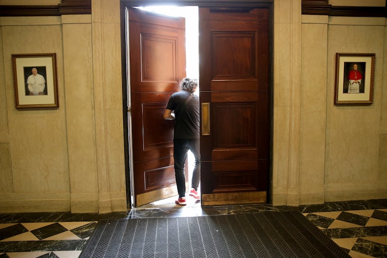 A visitor leaves near the end of a mass for the Assumption of the Blessed Virgin Mary at Cathedral Basilica of Saints Peter and Paul in Philadelphia, on Wednesday, Aug. 15.