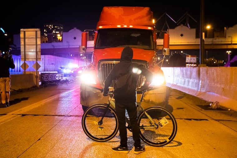 A protester stops traffic on the Delaware Ave. exit on I-95 south on Sept. 24, 2020 to protest the Breonna Taylor grand jury ruling