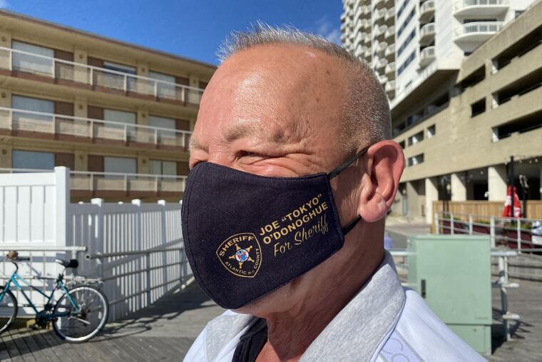 With a "Tokyo Joe" mask, Joe O'Donoghue campaigns on the Atlantic City Boardwalk on Sunday. The nickname dates to his youth, and to a grandfather who was the first Japanese American given citizenship in Atlantic County. O'Donoghue wants to be sheriff of Atlantic County.