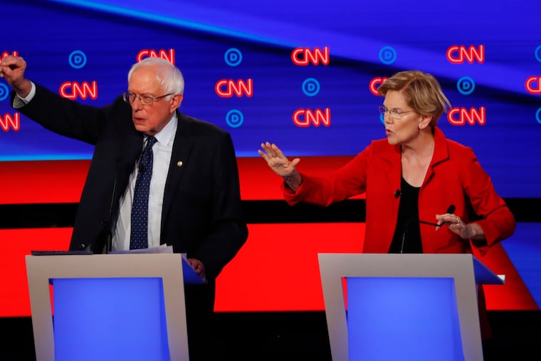 Sen. Bernie Sanders, I-Vt., and Sen. Elizabeth Warren, D-Mass., talk during in the first of two Democratic presidential primary debates hosted by CNN Tuesday, July 30, 2019, in the Fox Theatre in Detroit. (AP Photo/Paul Sancya)