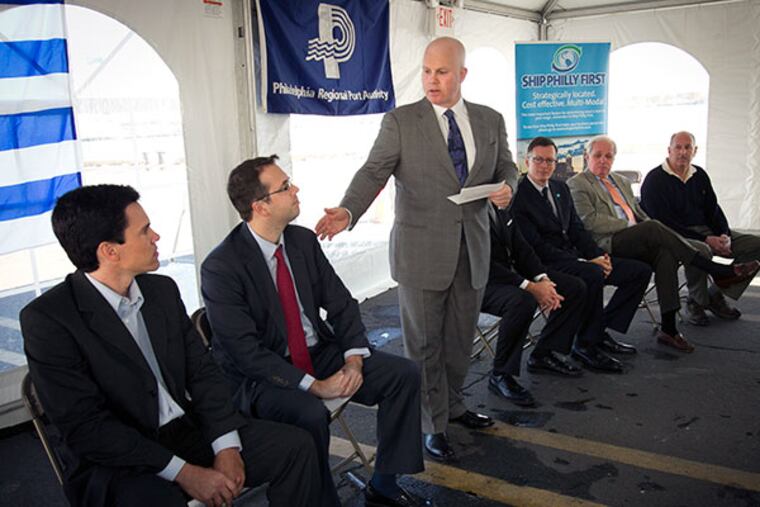 Leo Holt, President of Holt Logistics Corp gestures to Ricardo Baluga, Deputy Chief of Mission, Embassy of Uruguay. Local business leaders gathered at the Parker Marine Terminal on Christopher Columbus Blvd in south Philadelphia on Monday morning November 18, 2013 to announce the import of fruit from Uruguay to the region through the port in Philadelphia. At far left is Tony Fraschini, with UPEFRUY an organization of Uruguayan Growers and Exporters. ( ALEJANDRO A. ALVAREZ / STAFF PHOTOGRAPHER )