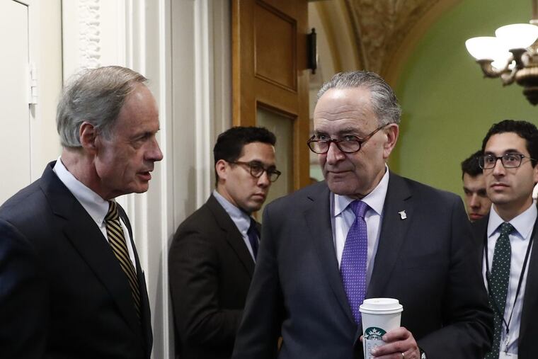 Sen. Tom Carper (left) confers with Senate Minority Leader Charles Schumer (D., N.Y.) on Capitol Hill.
