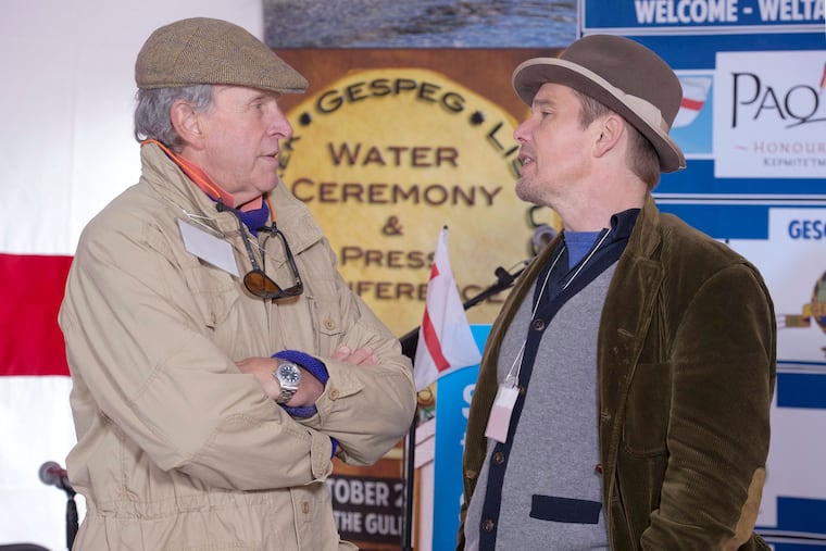 Actor Ethan Hawke, right, talks with Charles Gaines as they attend the Mi'kmaq community's water ceremony on the shores of Pomquet Harbour to support the aboriginal call for a moratorium on oil and gas exploration in the Gulf of St. Lawrence, near Antigonish, Nova Scotia, on Oct. 26, 2015.