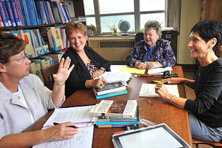 Sister Pat Mengel (left), Linda Robinson, Carolynne Ervin, Pat Latshaw meet at the library at Chestnut Hill College for a postgraduate program. Ervin is coordinator of the spiritual direction practicum, and the others are students. (Bonnie Weller / Staff)