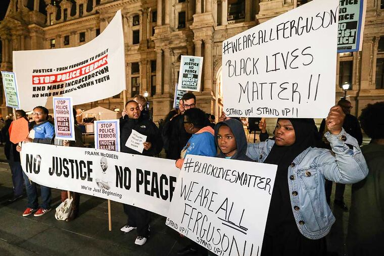 Dashay Moody and her son Martin, 12, at right during the Ferguson protests at City Hall, Monday, November 24, 2014. (Steven M. Falk / Staff Photographer )