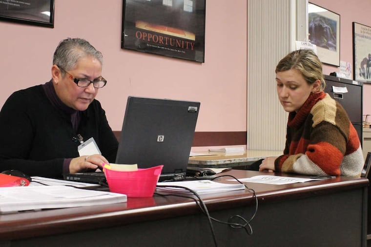 At the Campaign for Working Families, Mary Arthur (left) talks with Anastasia Gelashvilli. Campaign for Working Families offers free tax filing assistance.