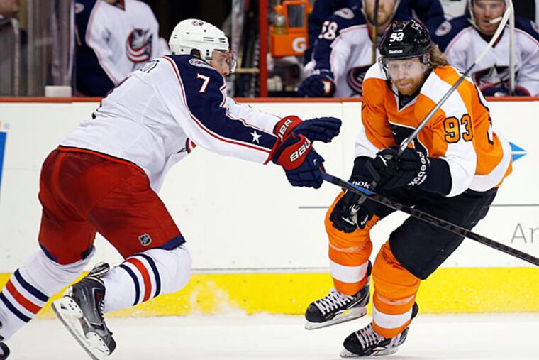 Jakub Voracek goes after the puck against the Blue Jackets' Jack Johnson. (Yong Kim/Staff Photographer)