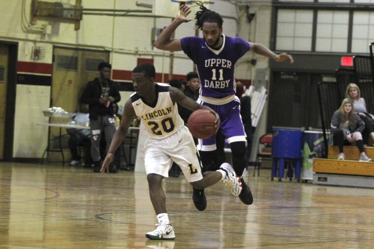 Lincoln’s Sahnei Day dribbles upcourt as Upper Darby’s Madg Abdelwand pursues him.