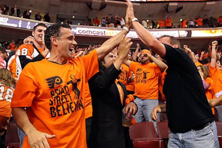 Flyers fans celebrate after Claude Giroux's game-winning goal in overtime. (Steven M. Falk/Staff Photographer)