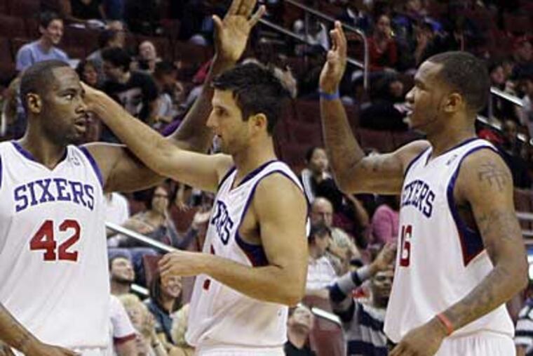 Jason Kapono is celebrates with teammates during a preseason game. (Matt Slocum / AP Photo)