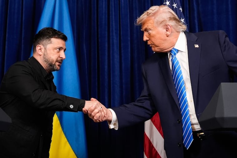 President Donald Trump and Ukraine's President Volodymyr Zelensky shake hands at the start of a joint news conference following a meeting at Trump's Mar-a-Lago resort in December in Palm Beach, Fla.