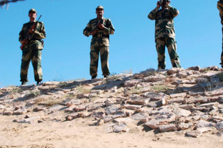 Indian soldiers keep watch along the border at Ranjitpura, India. New Delhi warned Pakistan about its troop buildup.