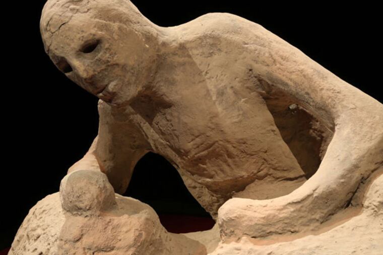 A plaster cast of one of the people of Pompeii killed by the eruption is part of the exhibition "One Day in Pompeii" at the Franklin Institute.