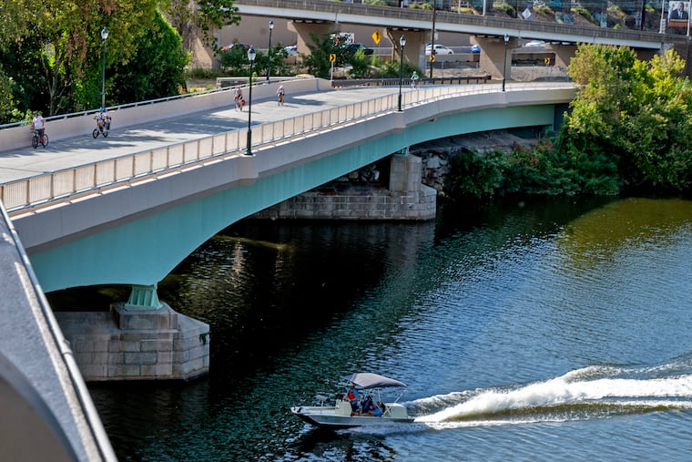 A boater on the Schuylkill passes under the Martin Luther King Jr. Drive Bridge in Fairmount Park in September.