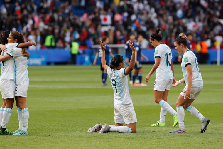 Argentina players celebrate after the final whistle of their tie against Japan.
