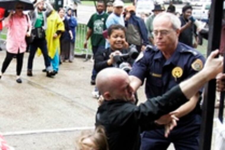 Protesters fall to the ground outside New Orleans City Hall.The vote to demolish the public housing units was unanimous.