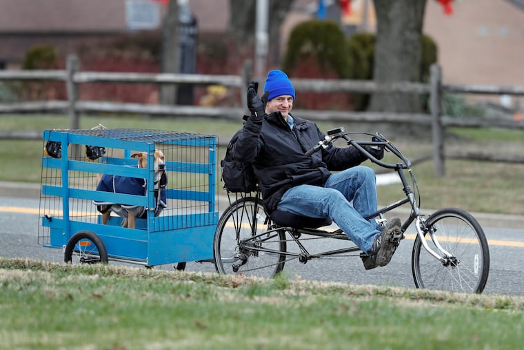 Karl Muehter and his dog Bosco ride home from the Timber Creek Dog Park in Blackwood, N.J. on Dec. 26, 2020.