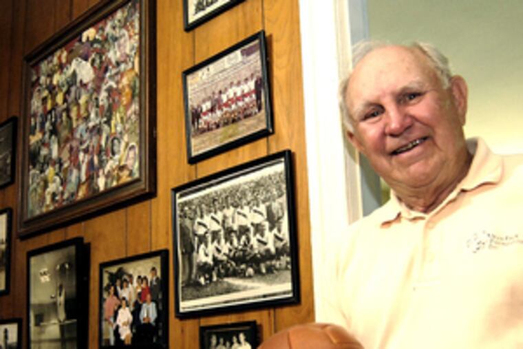 Walter Barr stands in his den, where soccer memorabilia and photos decorate the wall. Bahr, 80, said he planned to attend today's news conference announcing the return of pro soccer to the region.