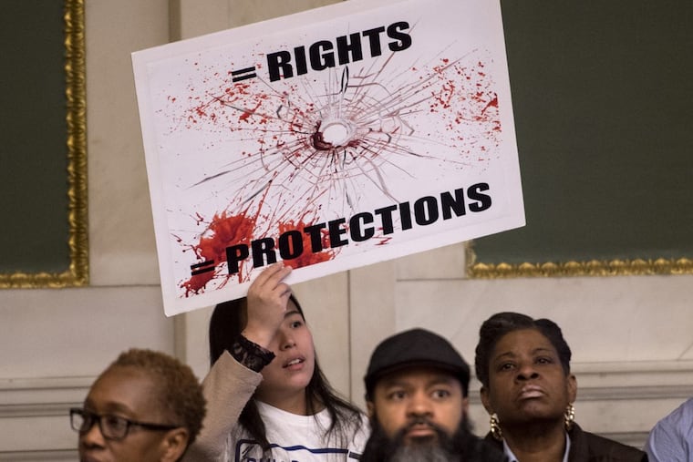 Hundreds, including Ying Xiao, who owns a beer deli, gather inside City Council Chambers on Dec. 4, 2017 to rally against a bill introduced by Councilwoman Cindy Bass that would force beer deli owners to take down protective safety windows in their establishments. The bill was being discussed by the Committee on Public Health and Human Services, of which Bass is the chair. (Clem Murray/Philadelphia Inquirer/TNS)