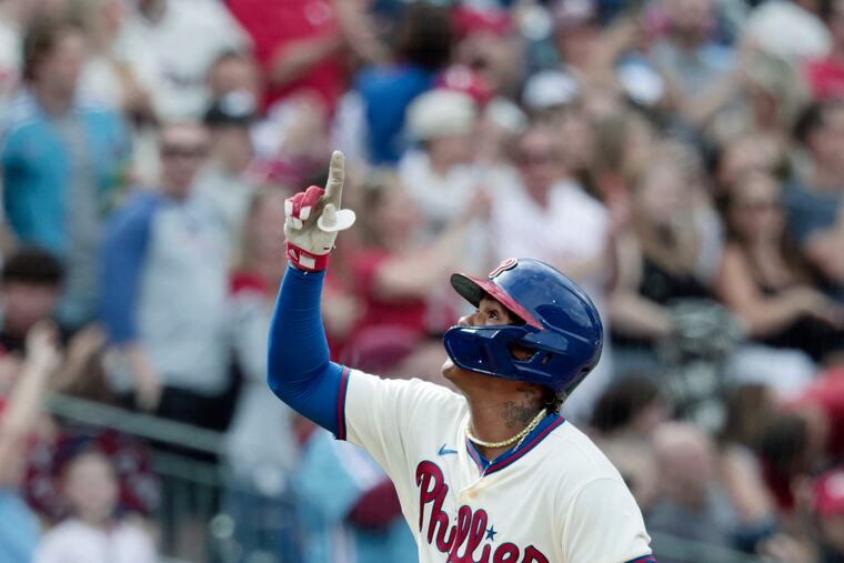 Cristian Pache points to the sky as he crosses home plate after hitting a two-run home run in the third inning Saturday against the Rockies. It was Pache's first homer as a Phillie.