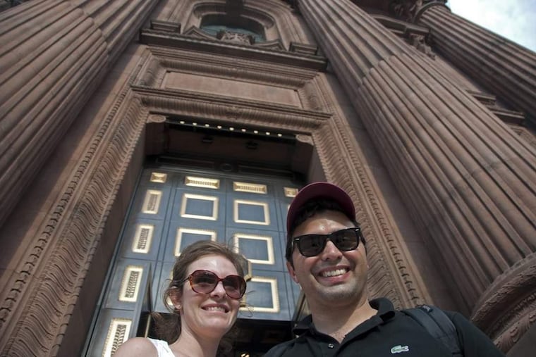 Debora Soares, 30, of São Paulo Brazil, stands with her husband Fillipe, 30, in front of the Cathedral Basilica of Saint Peter and Paul on Sunday afternoon before mass. The two are visiting Philadelphia, and the US, for the first time. ( ABI REIMOLD / STAFF PHOTOGRAPHER )
