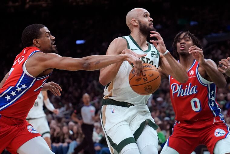 Sixers guard De'Anthony Melton (left) strips the ball from Boston's Derrick White. Tyrese Maxey is at right.
