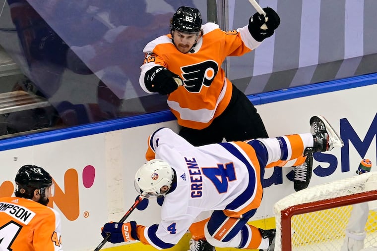 Flyers right wing Nicolas Aube-Kubel (62) checks New York Islanders defenseman Andy Greene behind the net during the first period of Game 7.