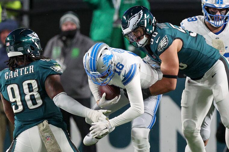 Eagles edge rusher Jaelan Phillips sacks Lions quarterback Jared Goff as Jalen Carter moves in.