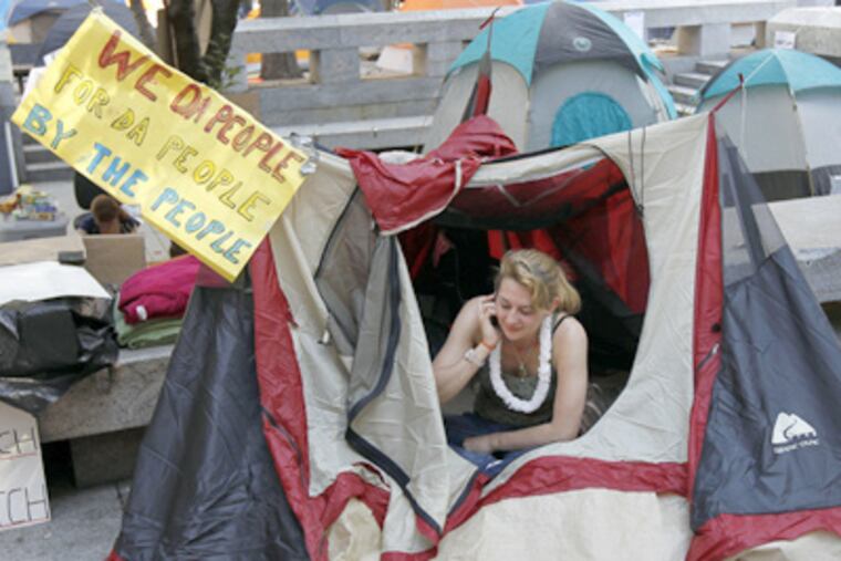 Elisabeth Levinson, from Philadelphia, sits in her tent near City Hall
Sunday for Occupy Philadelphia. (AP Photo/Alex Brandon)