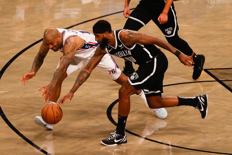 Sixers forward P.J. Tucker gets fouled going after the loose ball against the Nets' Royce O'Neale in the second quarter of Game 3.