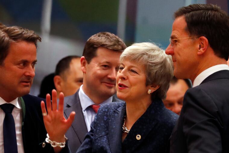 British Prime Minister Theresa May speaks with Dutch Prime Minister Mark Rutte (right) and Luxembourg's Prime Minister Xavier Bettel (left) during a roundtable meeting at an EU summit in Brussels, Thursday, March 21, 2019.