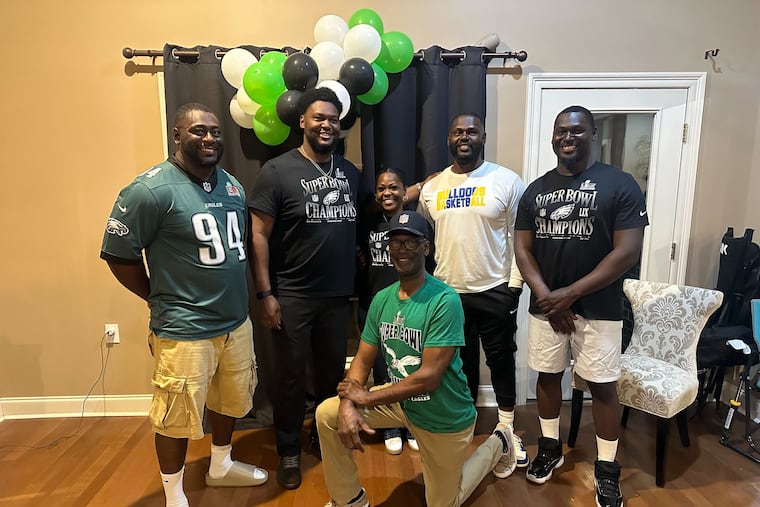 Eagles defensive tackle Byron Young (second from left) with father Kenny (front) and siblings Kendrick (left), Shavon (center), Regrick (second right) and Brandon (right).