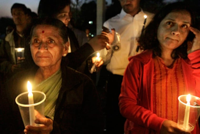 Attendees hold candles at a vigil for 10-month-old Saanvi Venna, kidnapped from the apartment in King of Prussia where her grandmother was killed. ELIZABETH ROBERTSON / Staff