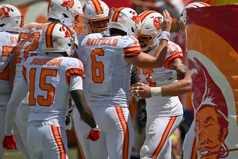 Tampa Bay quarterback Baker Mayfield (6) celebrates with wide receiver Mike Evans (13) after Evans' touchdown during Sunday's win over the Jets.