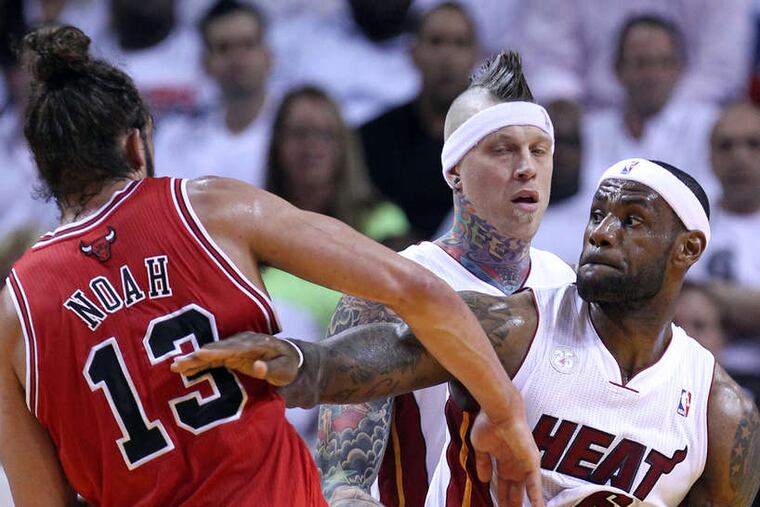 The Heat's LeBron James shoves Chicago's Joakim Noah in Game 2. James scored 19 points in Miami's win. Chris Andersen watches the action. JOHN J. KIM / Chicago Tribune
