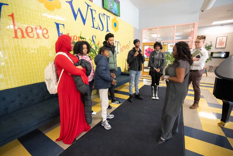 Principal Marla Travis (front right) talks with students at West Philadelphia High School, where enrollment is growing.