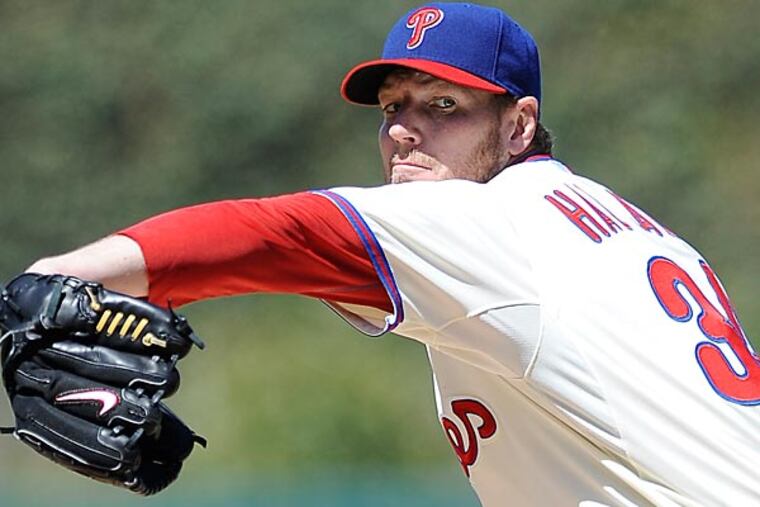You can be mad at Andrew Bynum or you can be mad at Roy Halladay. You can't be mad at both. (Michael Perez/AP)