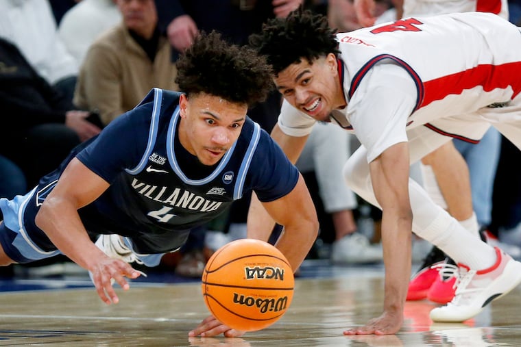 Villanova guard Tyler Perkins and St. John's guard Oziyah Sellers dive for a loose ball on Saturday.
