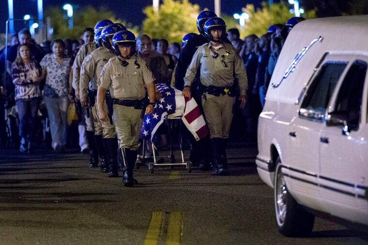 Slain CHP officer Andre Moye is transported to a hurst as his family follows from the Riverside University Health Systems Medical Center after he was shot and killed while two fellow officers were wounded during a traffic stop on Eastridge Avenue overpass over the 215 Freeway around 5:30p.m. in Riverside earlier today, in Moreno Valley on Monday, Aug 12, 2019.