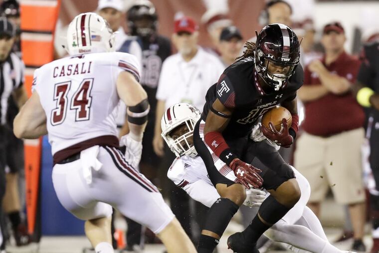 Temple wide receiver Isaiah Wright runs with the football past UMass safety Tyler Hayes (center) and linebacker Steve Casali (left) during the second-quarter on Friday, September 15, 2017 in Philadelphia. YONG KIM / Staff Photographer