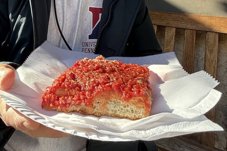 Kosuke Chujo prepares to try a tomato pie from Sarcone's Bakery in South Philadelphia in December 2023. Chujo isn't only researching cheesesteaks for his Philly-themed restaurant in Tokyo.