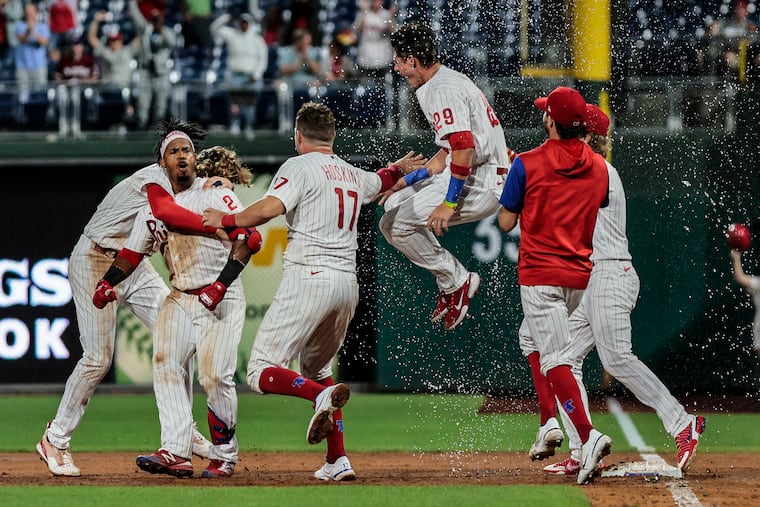 The Phillies congratulate Jean Segura on his walk-off hit to beat the Marlins on Tuesday.