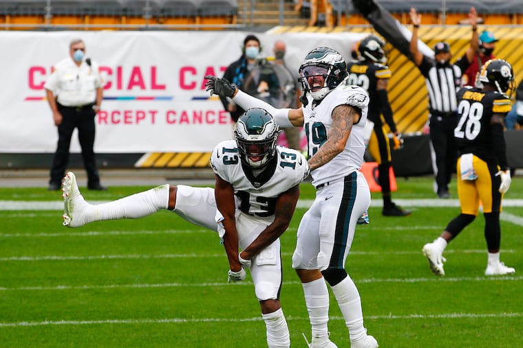 Eagles wide receiver Travis Fulgham (left) celebrates his fourth-quarter touchdown with teammate J.J. Arcega-Whiteside against the Steelers on Sunday.