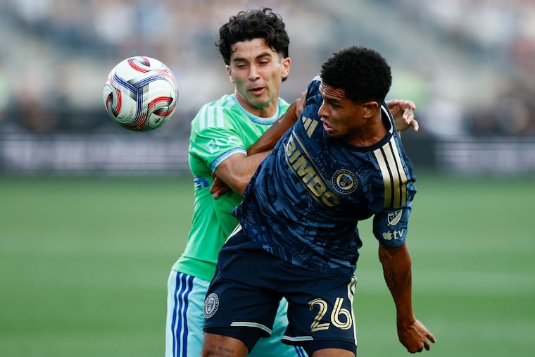 Union defender Nathan Harriel and Seattle Sounders forward Paul Rothrock battle for the ball during the first half on Saturday in Chester.