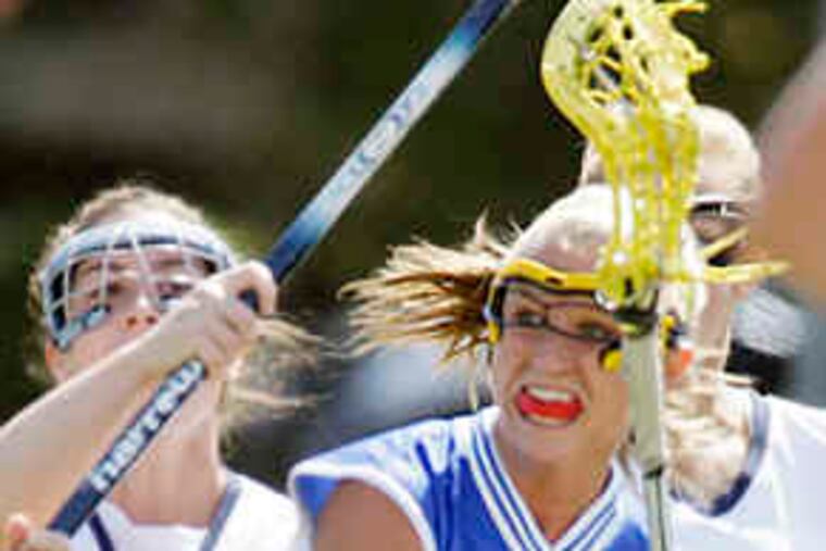 Shannon Burns of Springfield (Delco) works against Manheim Township defender Rachel Rosenfeld (4) in the 14-4 victory.