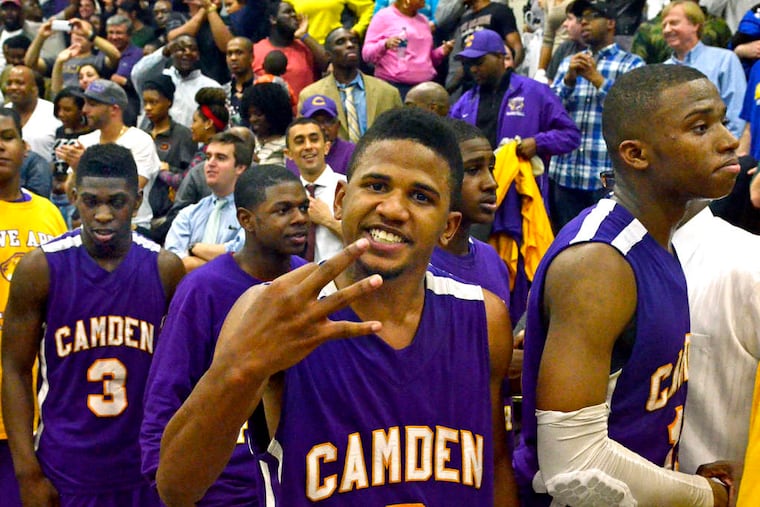 Tavaris Headen indicates how many sectional titles Camden has won in a row.