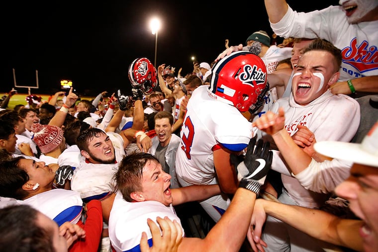 Neshaminy High School players and fans celebrate their 21-20 win over Pennsbury on a flea-flicker play in the final minute of their game Friday, October 27, 2017.