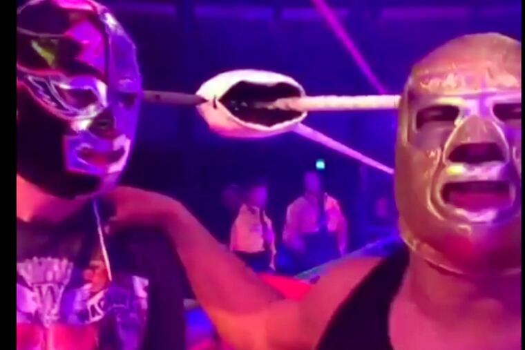 In this image made from video taken on Saturday, May 11, 2019, The Silver King, right, talks to the camera with fan Mark van der Enden at the Roundhouse in London. A fan of a wrestler and actor who died after collapsing on stage mid-performance in London shared the moment he got to meet his idol earlier that afternoon. Cesar Cuauhtemoc Gonzalez Barron, also known by his wrestling title of Silver King, died of a suspected heart attack at the Roundhouse in London's Camden on Saturday night, promoters said. (@estefyunvin via AP)