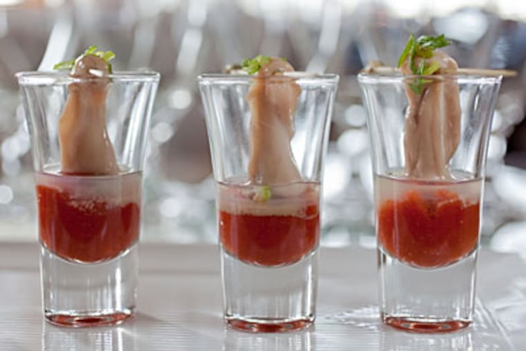 Latitudes' oyster shooters. (DAVID M WARREN / Staff Photographer)
